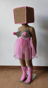 Sculptural work titled Hi, they call me Honey Pie by contemporary artist Nanon Morsink, made from rope, can tabs, tulle, thread, wool, and a doll.