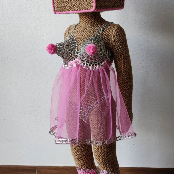 Sculptural work titled Hi, they call me Honey Pie by contemporary artist Nanon Morsink, made from rope, can tabs, tulle, thread, wool, and a doll.