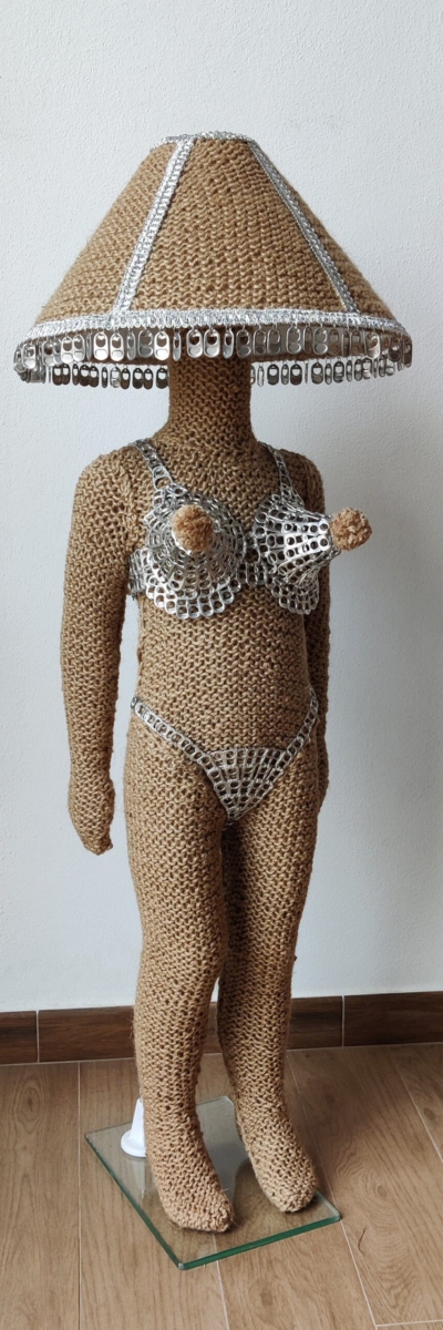 Sculptural work (working lamp) titled Hi, they call me Candy (Candy lamp) by contemporary artist Nanon Morsink, made from rope, can tabs, a lamp shade, and a doll.