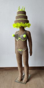 Sculptural work titled You’re a big girl, now by contemporary artist Nanon Morsink, made from rope, can tab, silver thread, wool, and a doll.