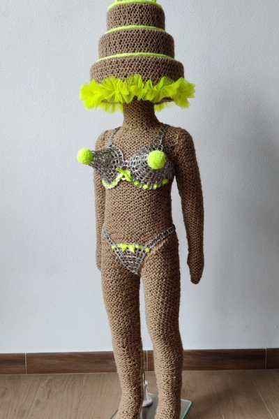 Sculptural work titled You’re a big girl, now by contemporary artist Nanon Morsink, made from rope, can tab, silver thread, wool, and a doll.