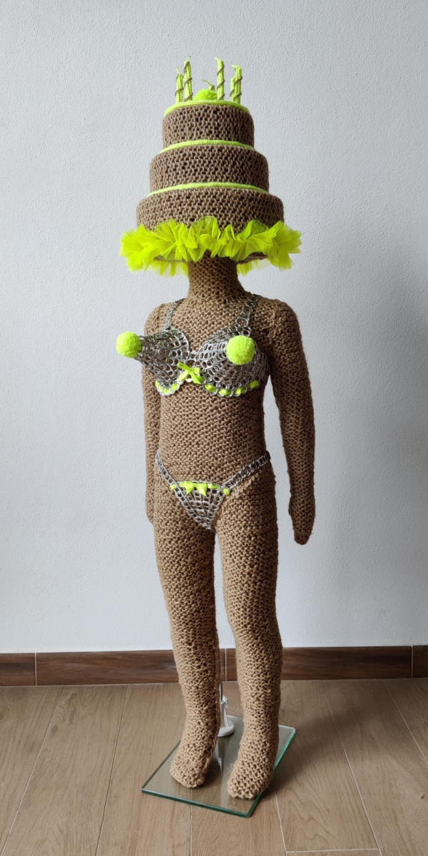 Sculptural work titled You’re a big girl, now by contemporary artist Nanon Morsink, made from rope, can tab, silver thread, wool, and a doll.