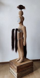 Sculptural work titled Little Amazon, fierce warrior by contemporary artist Nanon Morsink, made from rope, a can tab, hair, paint, and a doll.
