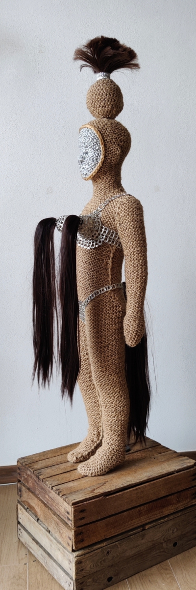 Sculptural work titled Little Amazon, fierce warrior by contemporary artist Nanon Morsink, made from rope, a can tab, hair, paint, and a doll.