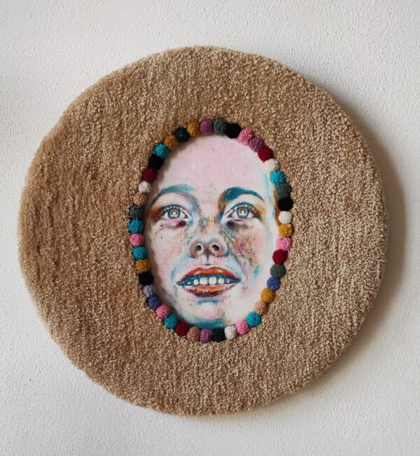 Contemporary textile wall sculpture titled “I Am Happy” by Nanon Morsink, part of the Soft Series. Mixed media with tufted wool, pompons, and acrylic paint on board, 50 cm diameter, 2025. Colorful circular fiber art.