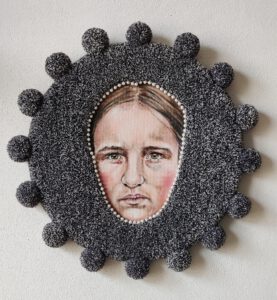 Contemporary textile artwork “I Am Worried” by Nanon Morsink, from the Soft Series. Circular fiber art piece with tufted wool, acrylic paint, pompons, pearls, and board. Emotional and tactile modern mixed media, 55 cm diameter, 2025.