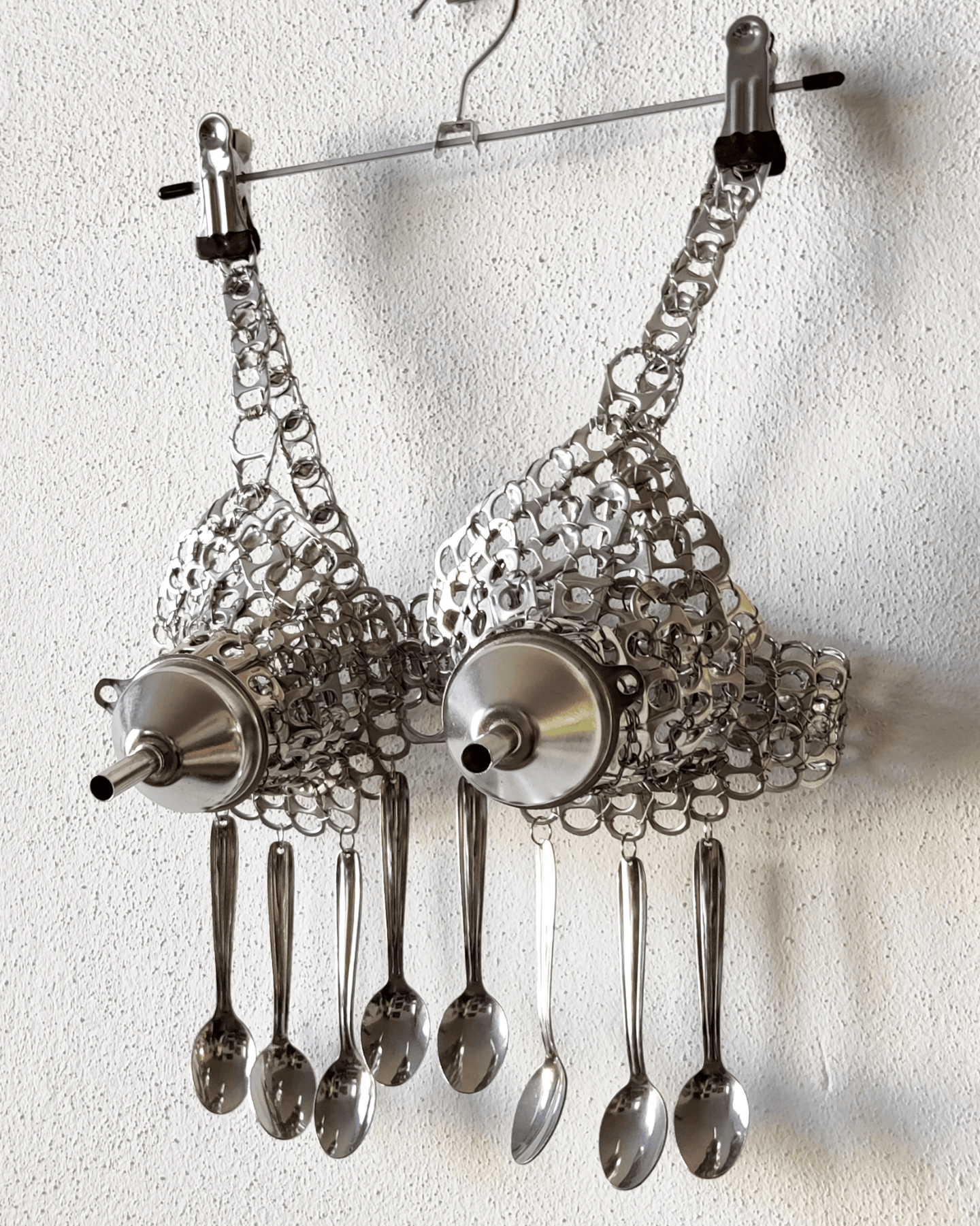 The Girl Can’t Cook II, Safety Lingerie Series, can tabs, silver thread, spoons, funnels by contemporary artist Nanon Morsink